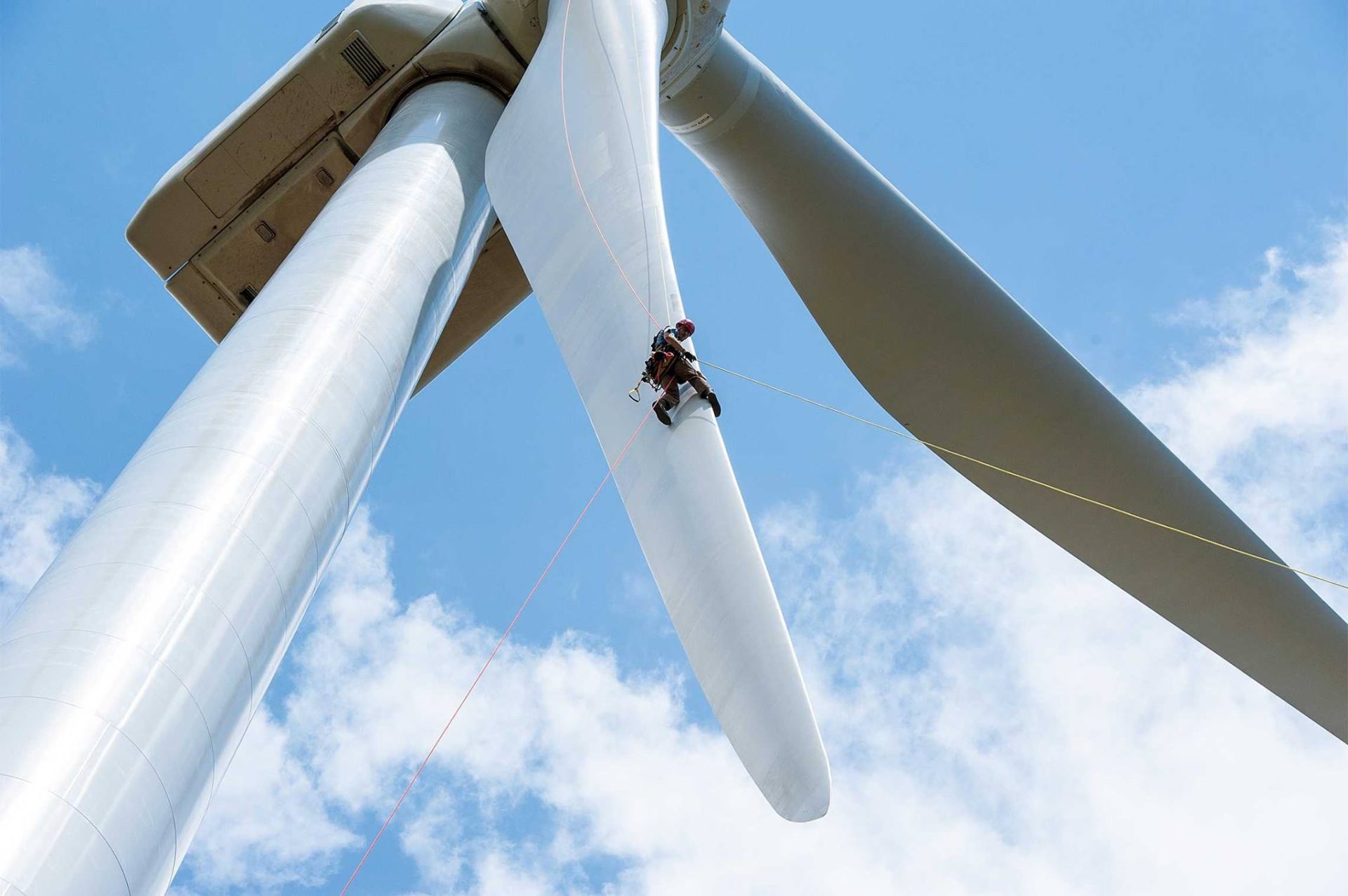 A wind energy worker services a turbine.  The latest IPCC report from the UN calls for a rapid move to more renewable energy.