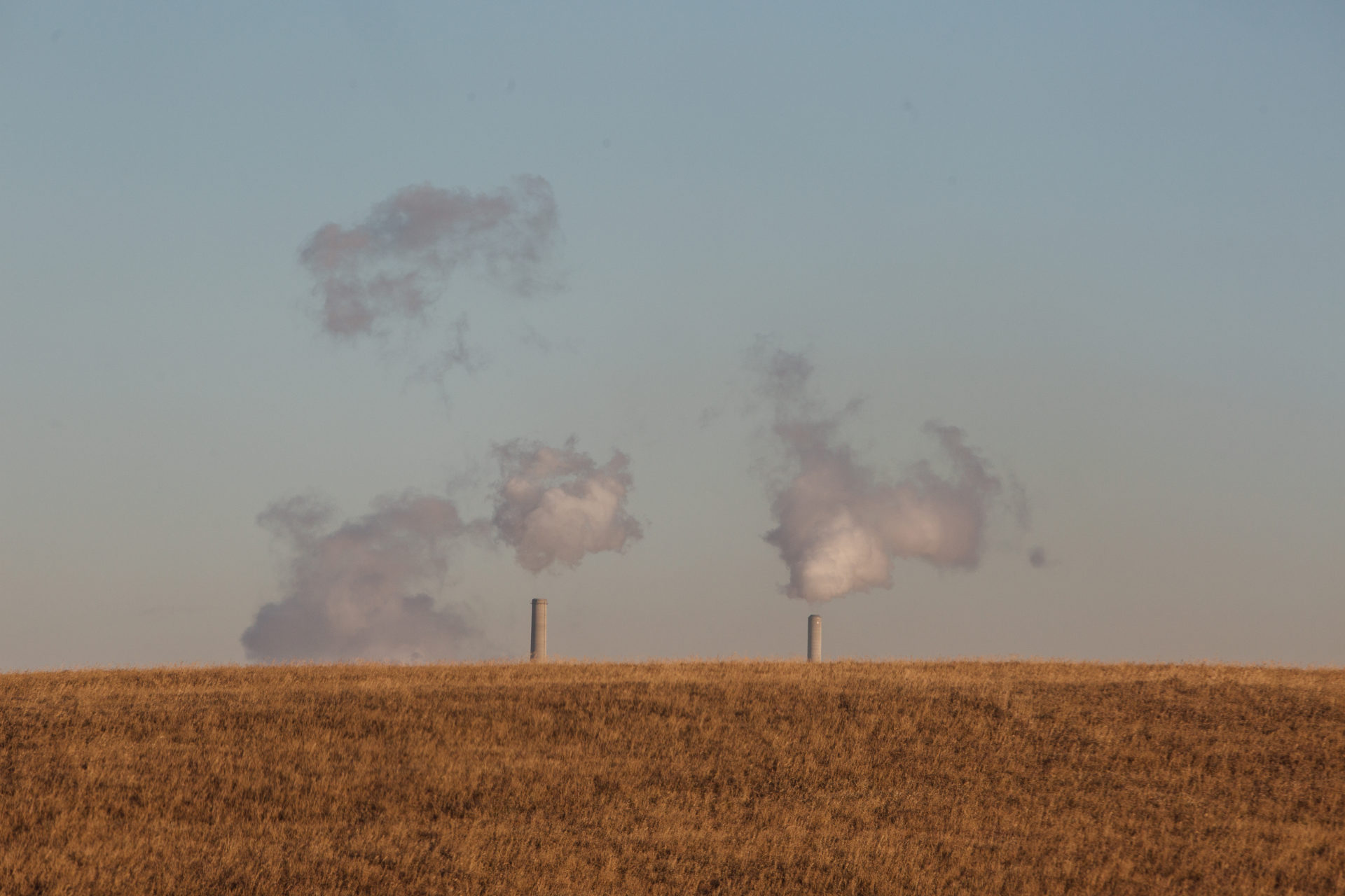 An Alberta coal plant, Keephills Power Station, is just visible behind a prairie field