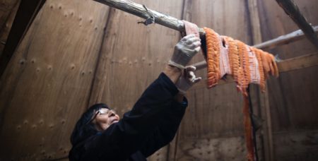 Dora Blondin hangs trout from Great Bear Lake
