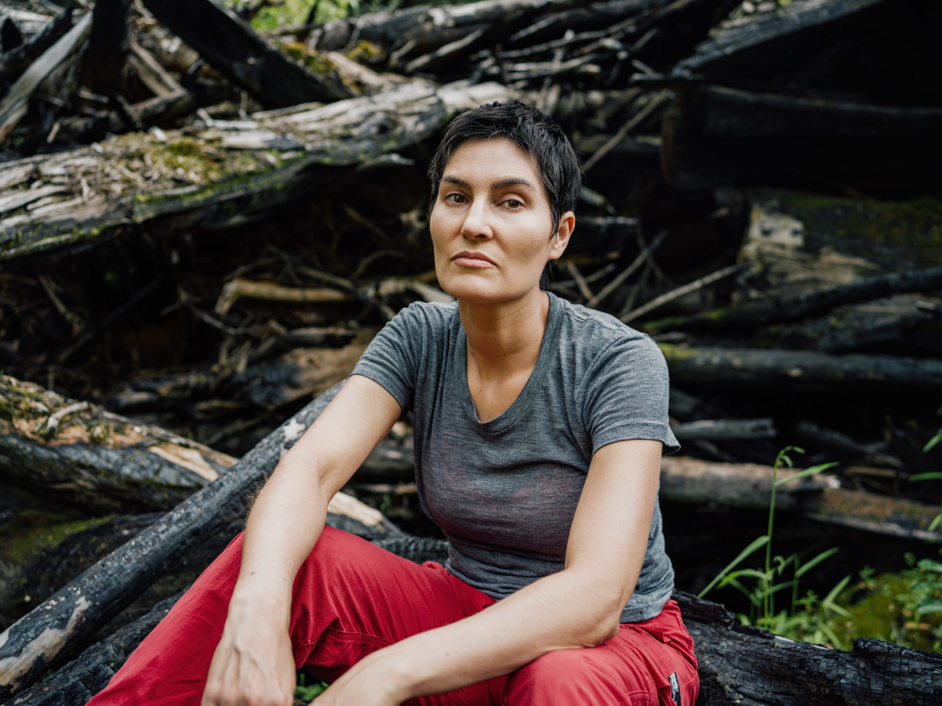 Scientist Michelle Connolly in a burnt slash pile