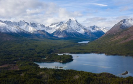 Kaska Dena Indigenous Protected and Conserved Area: snow-capped mountains behind a pristine mountain lake