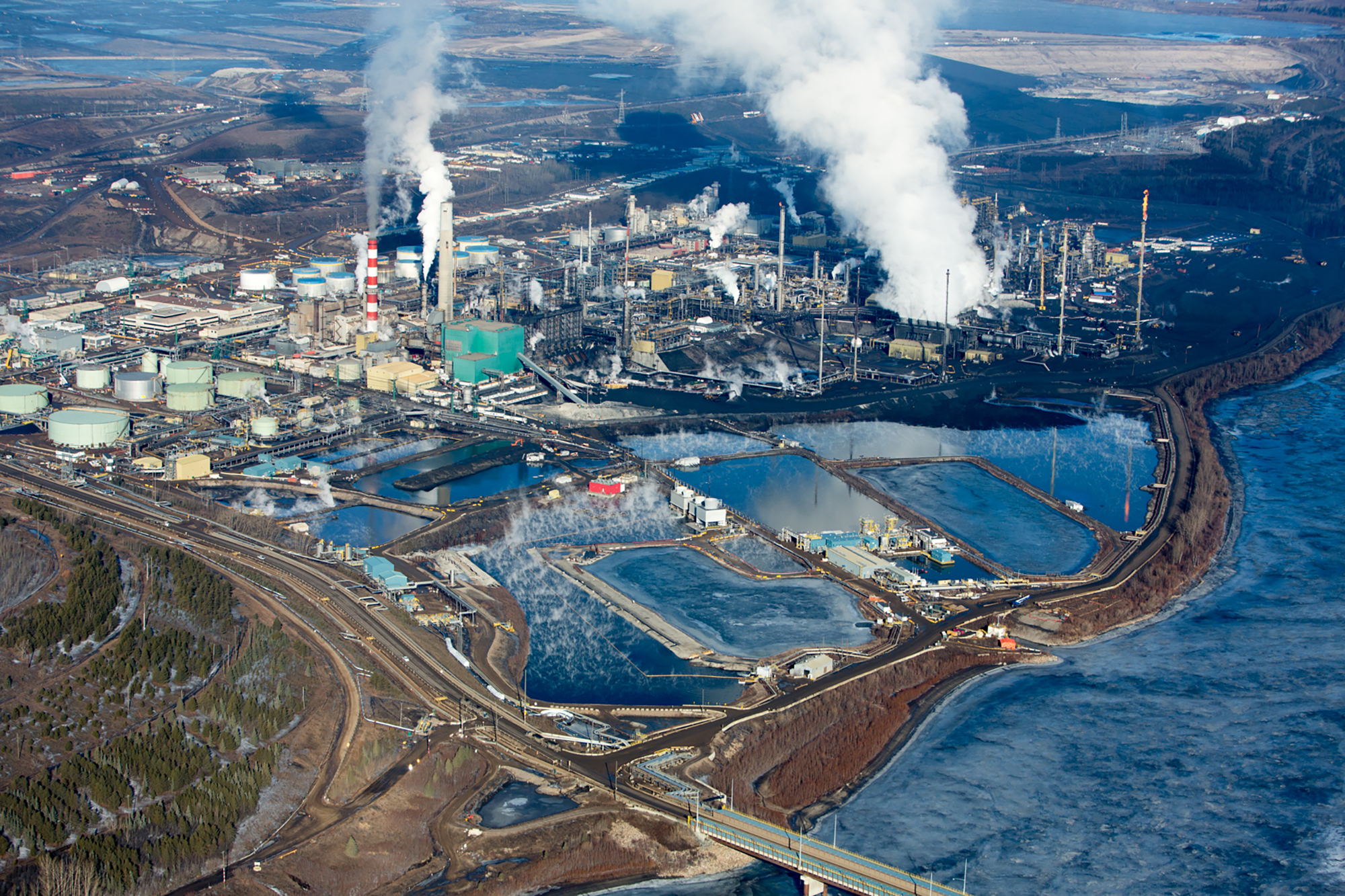 oilsands refinery from above with plumes of smoke