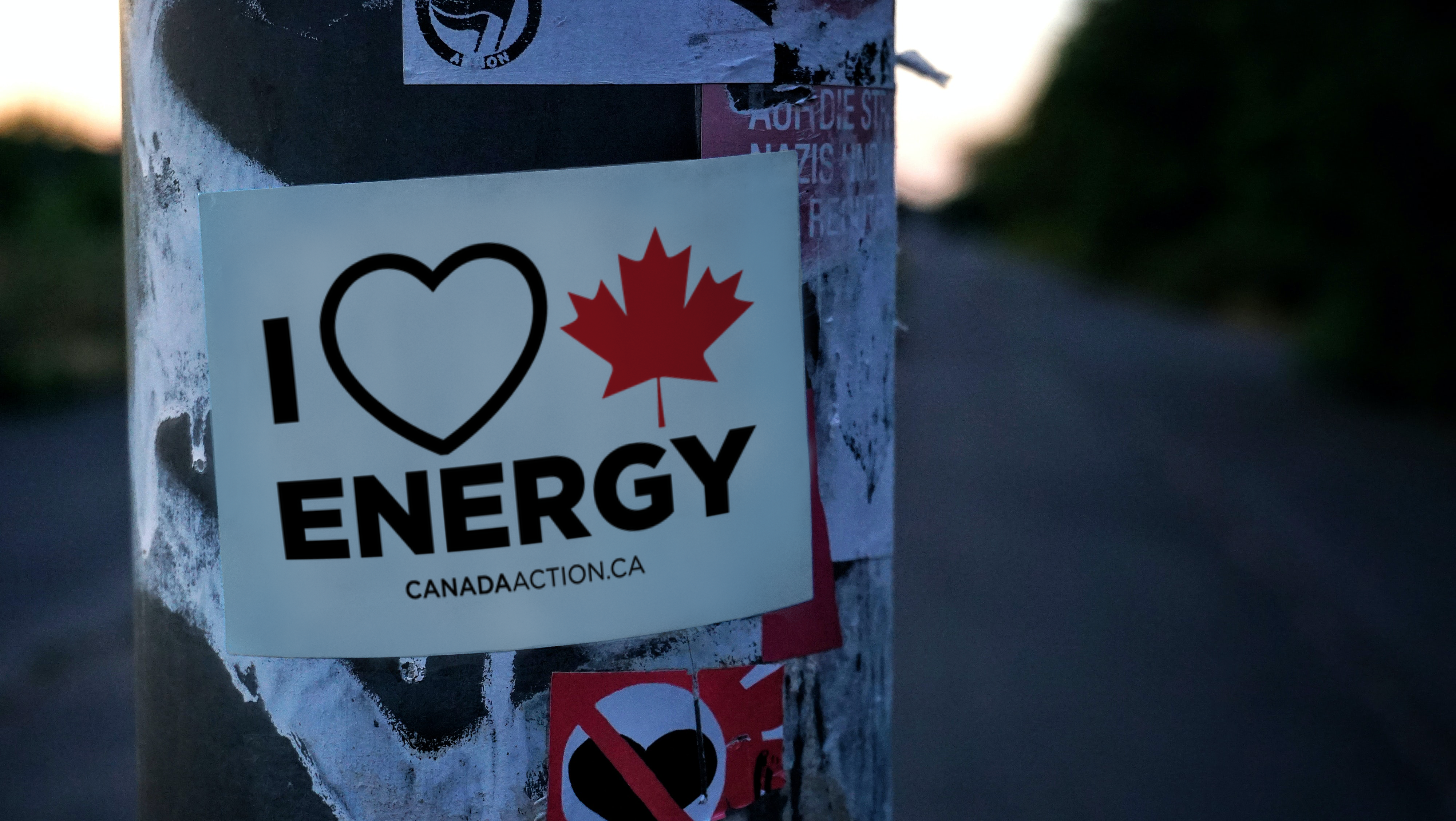 An "I heart Canadian energy" sign from Canada Action is seen posted to a pole.