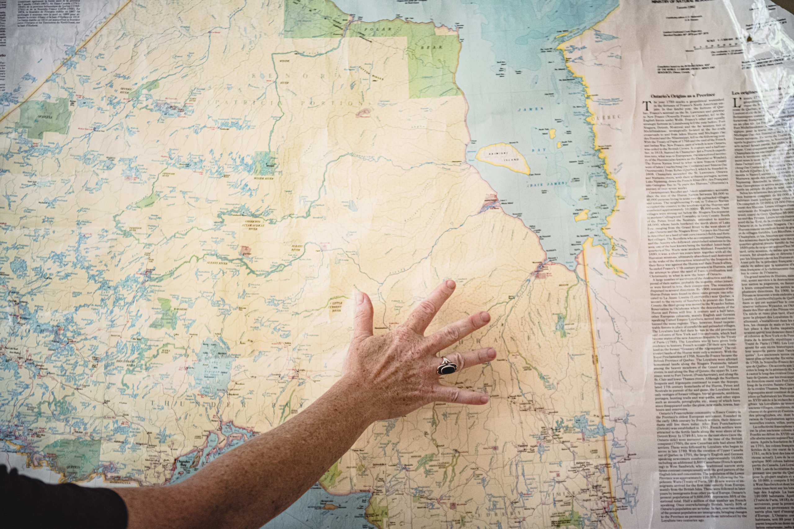 A hand hovering over a map of the Ring of Fire area in Ontario