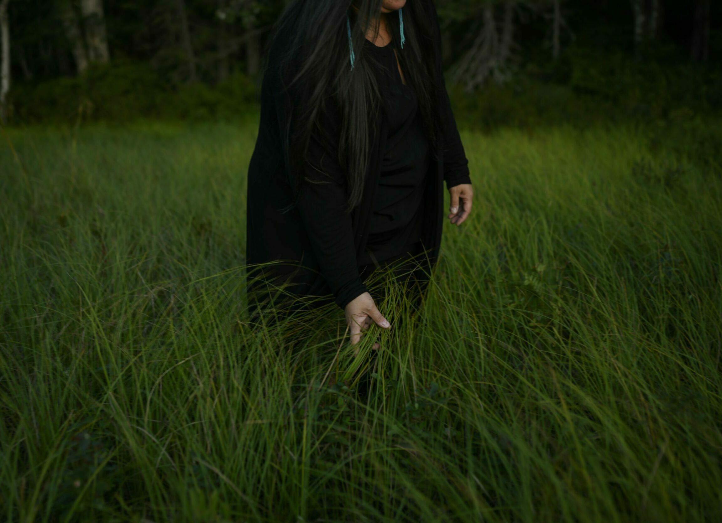 Melissa Labrador runs her hand through the tall grass