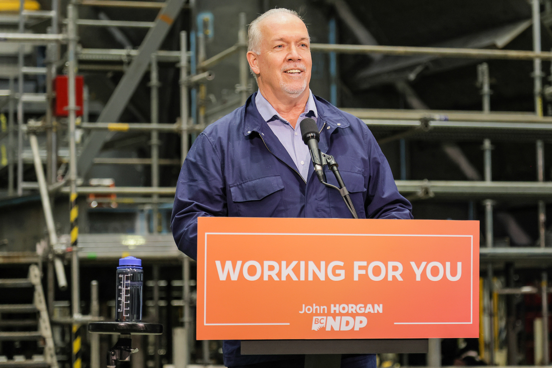 John Horgan BC NDP Leader standing at a podium indoors