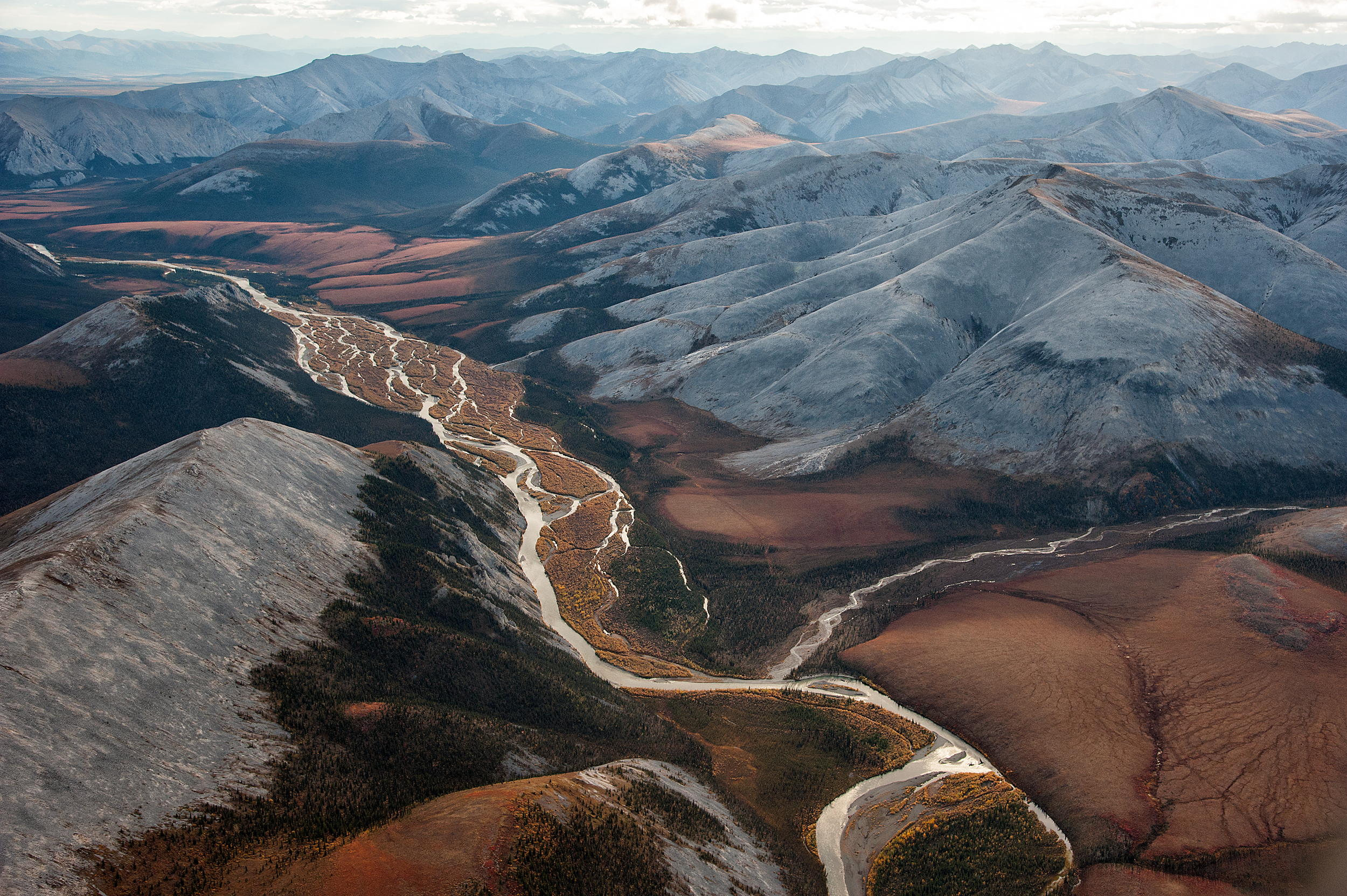 Aerial images of Ogilvie Mountains, Demspter Highway, and Tombstone Territorial Park in bright fall colours on the tundra.