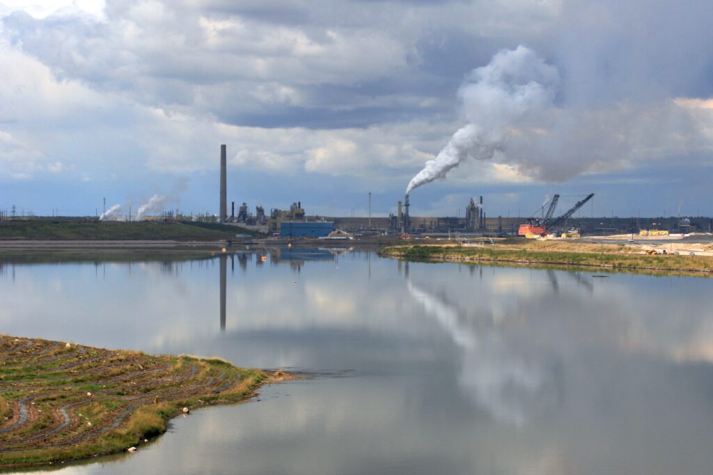 tailings pond in front of industrial setting