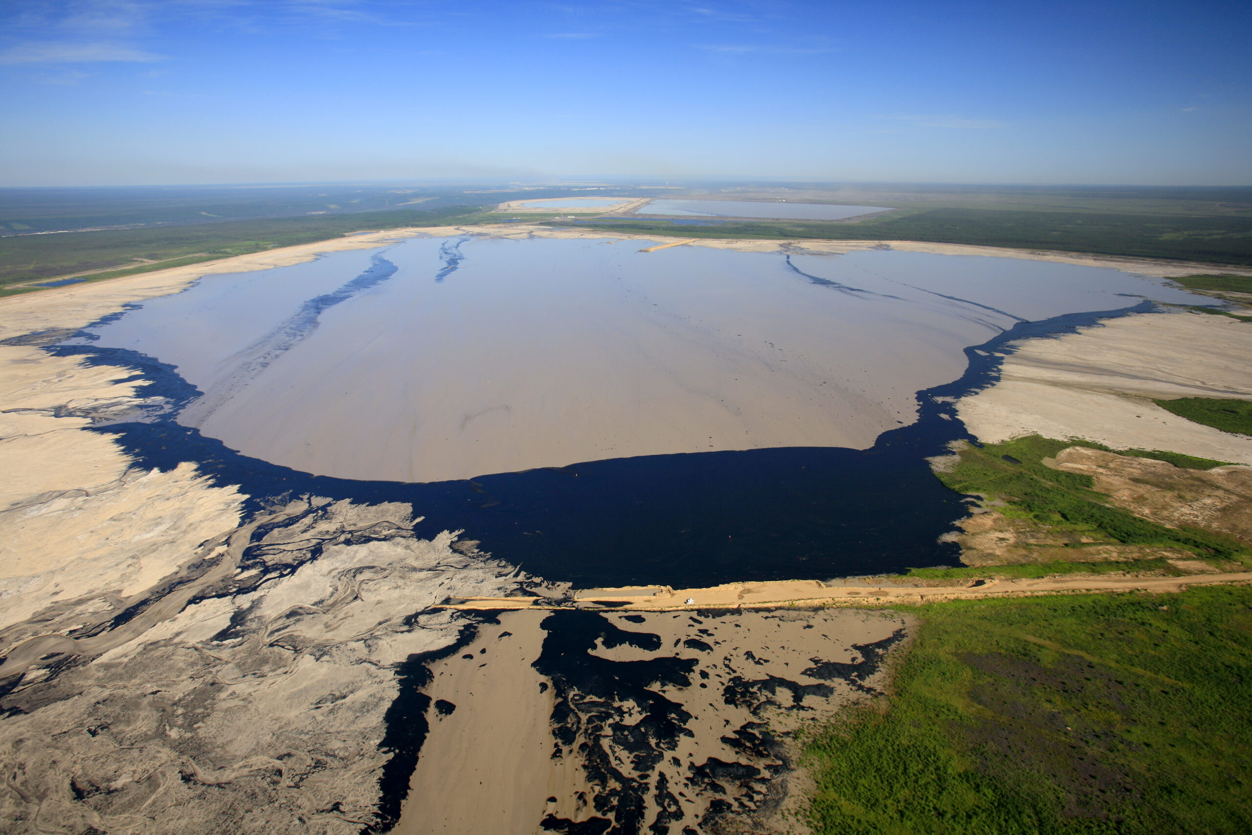 tailings pond from above in flat landscape