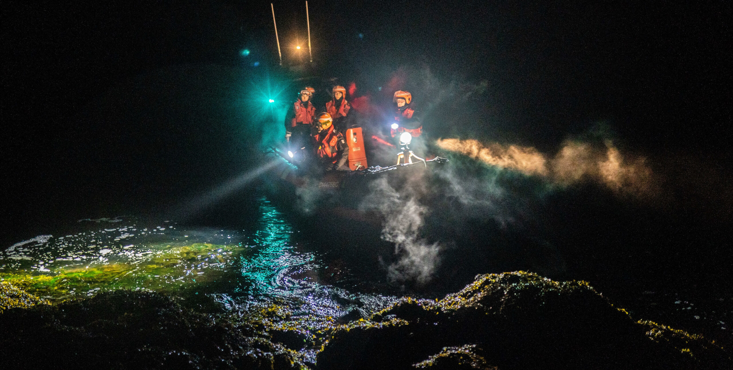 Students conducting a shore crawl search at night.