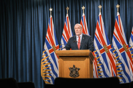 john horgan speaks at podium