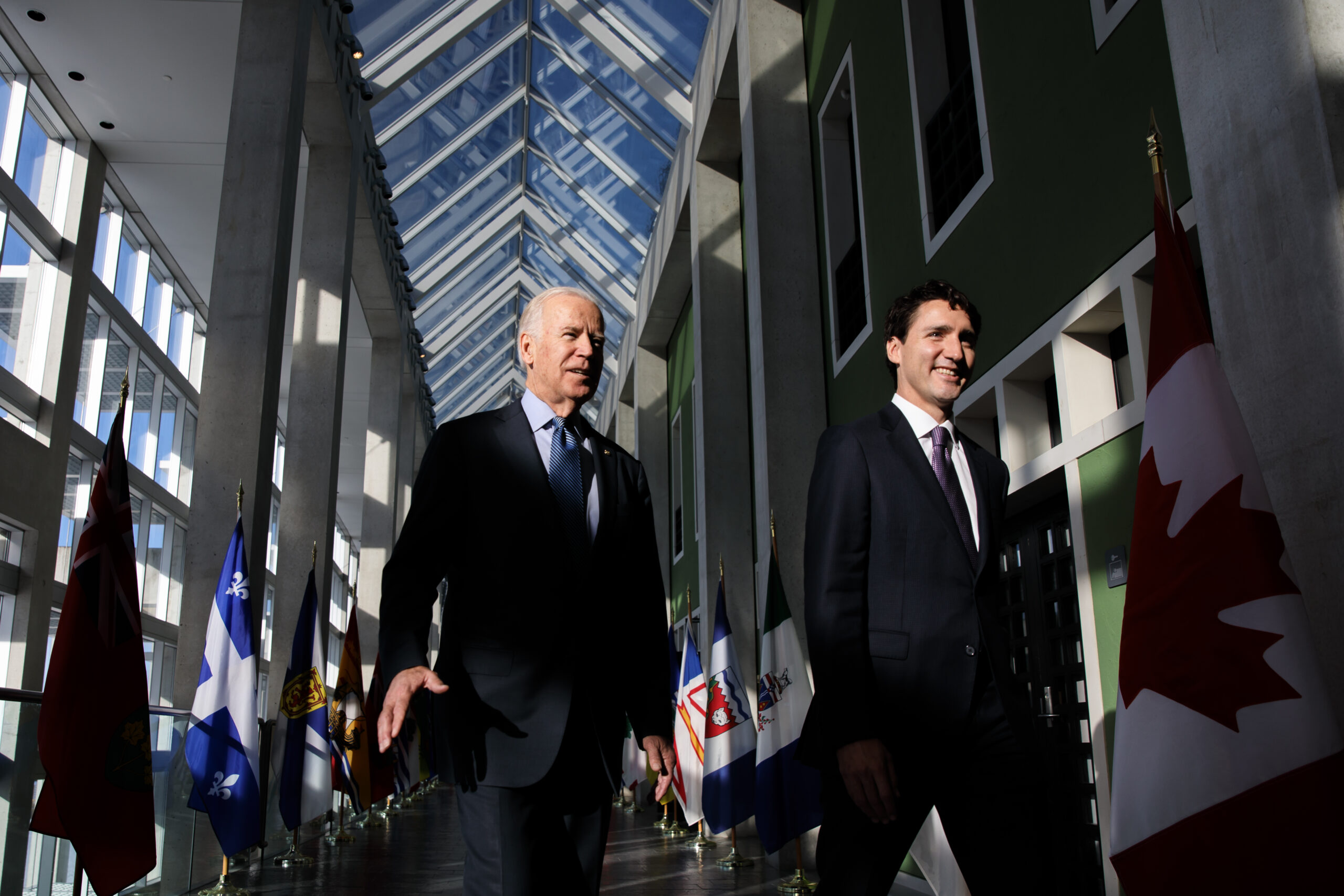 U.S. President Joe Biden and Prime Minister Justin Trudeau walking together indoors