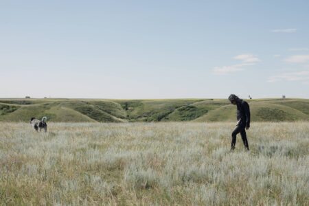 person walking in native grasslands