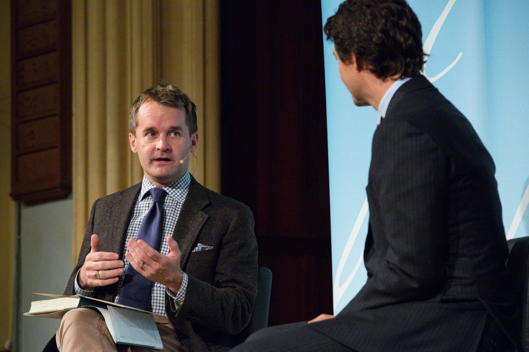 Seamus O'Regan speaking on a stage with Justin Trudeau