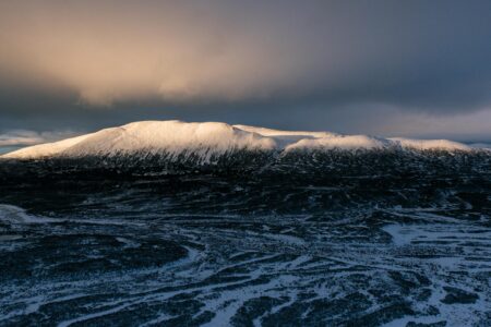 Light shining on the snowy top of a mountain in northern B.C.