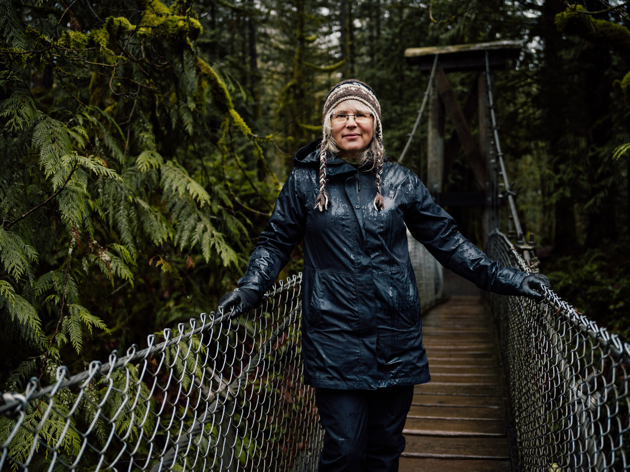 Cheri Ayers stands on a suspension bridge
