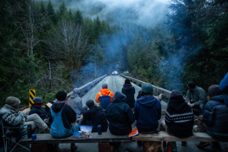 Blockaders prevent loggers from crossing a bridge