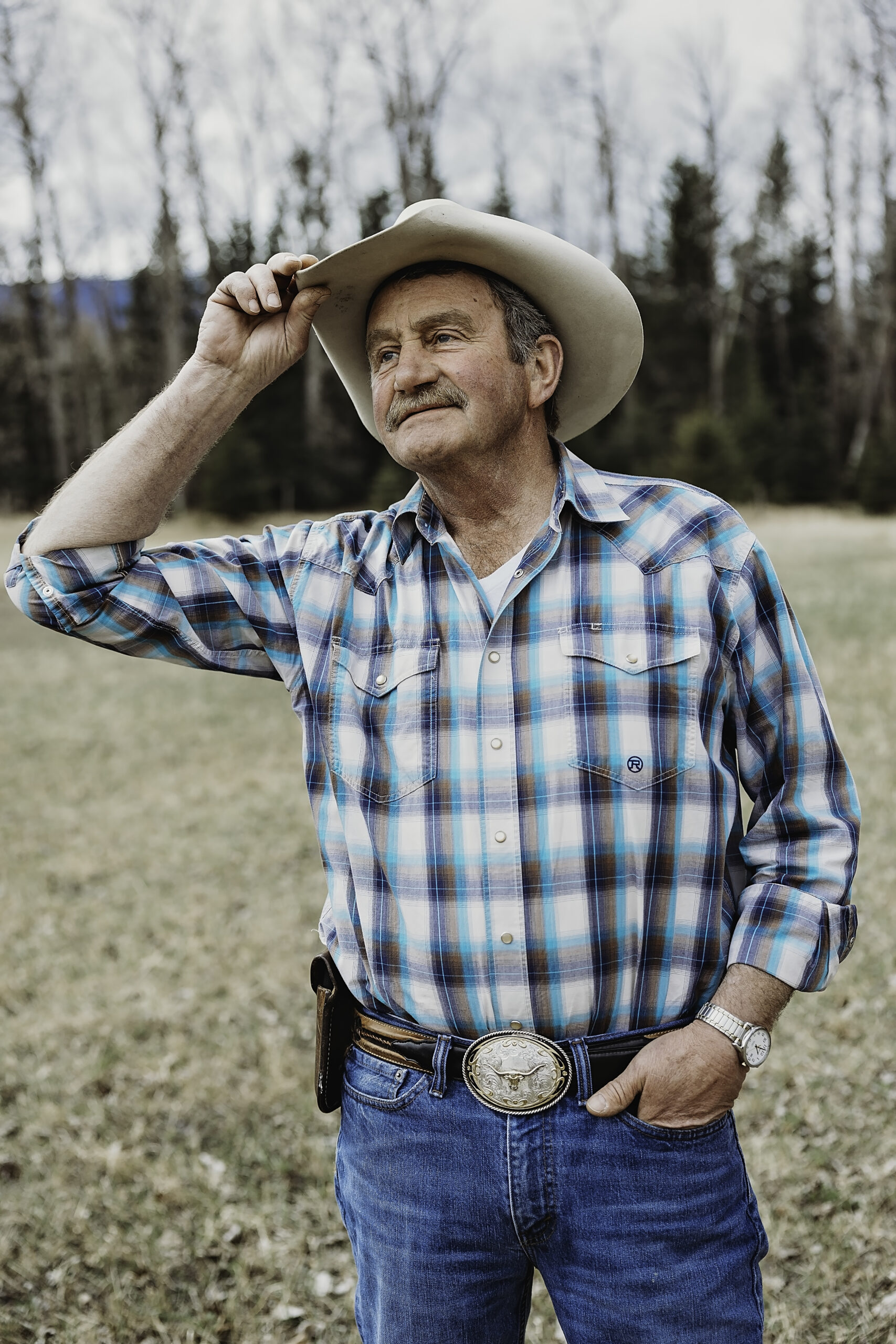 Rancher Rodger Peterson stands wearing a cowboy hat.