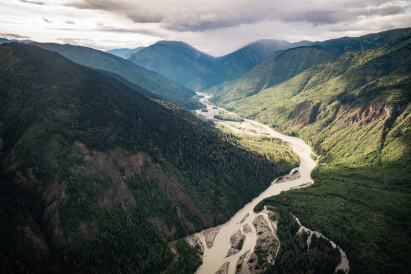 aerial view of boreal forest, mountains and river