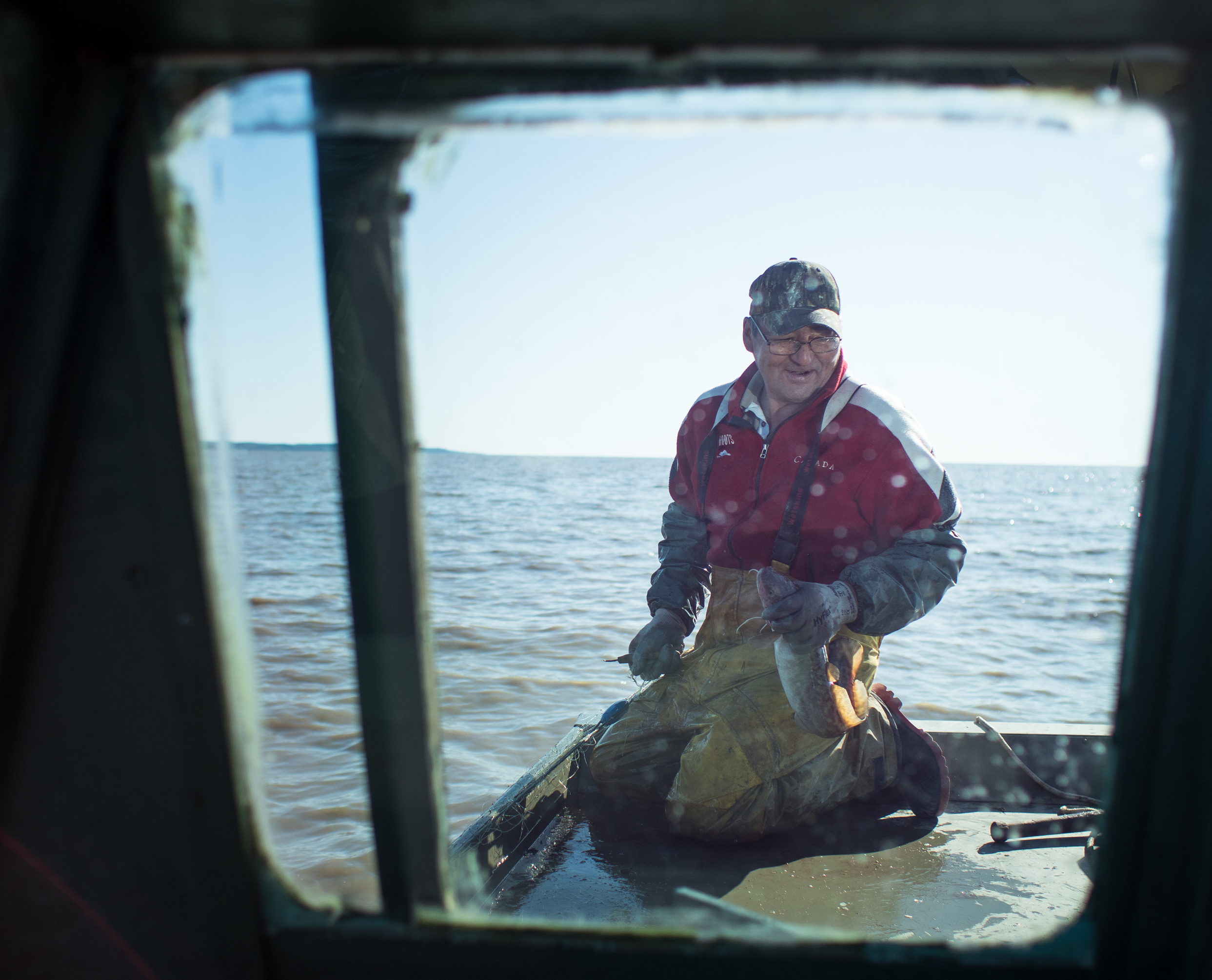 a man stands in a boat holding a fishing net