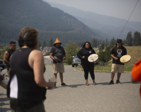 The Pil’alt Canoe Family, or River Spirit Canoe Family, sing and drum in a circle with members of the Nlaka’pamux First Nation