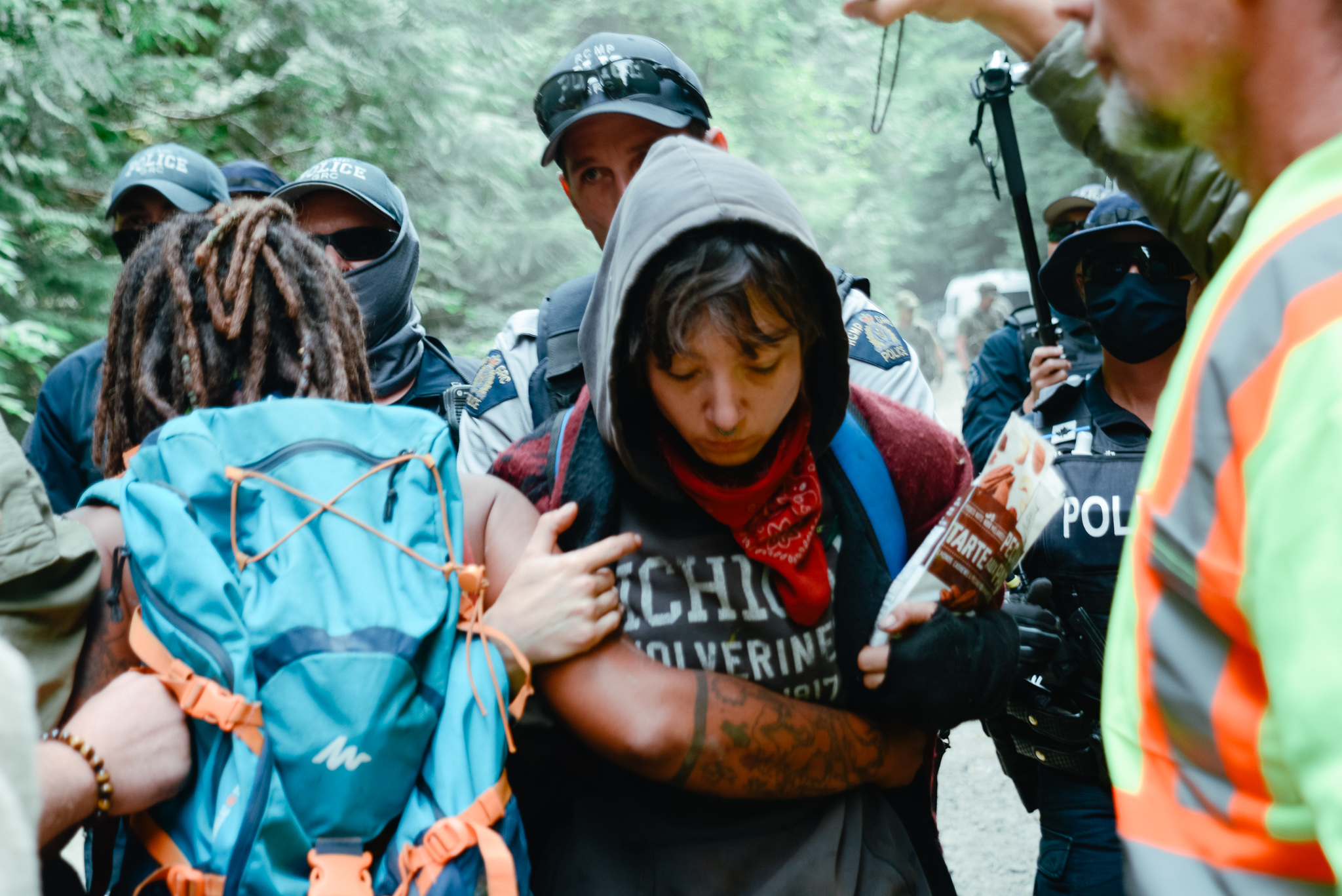 RCMP surrounding a protestor at Fairy Creek blockades