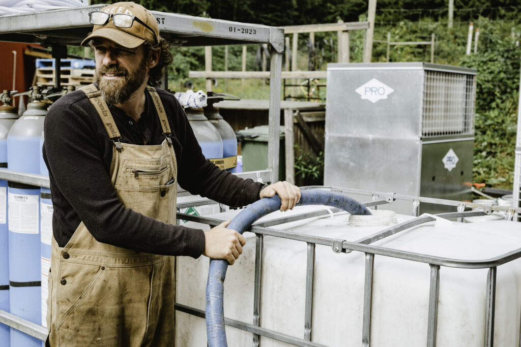 Brian Smith from the Persephone Brewing Company fills a water tank on the Sunshine Coast.