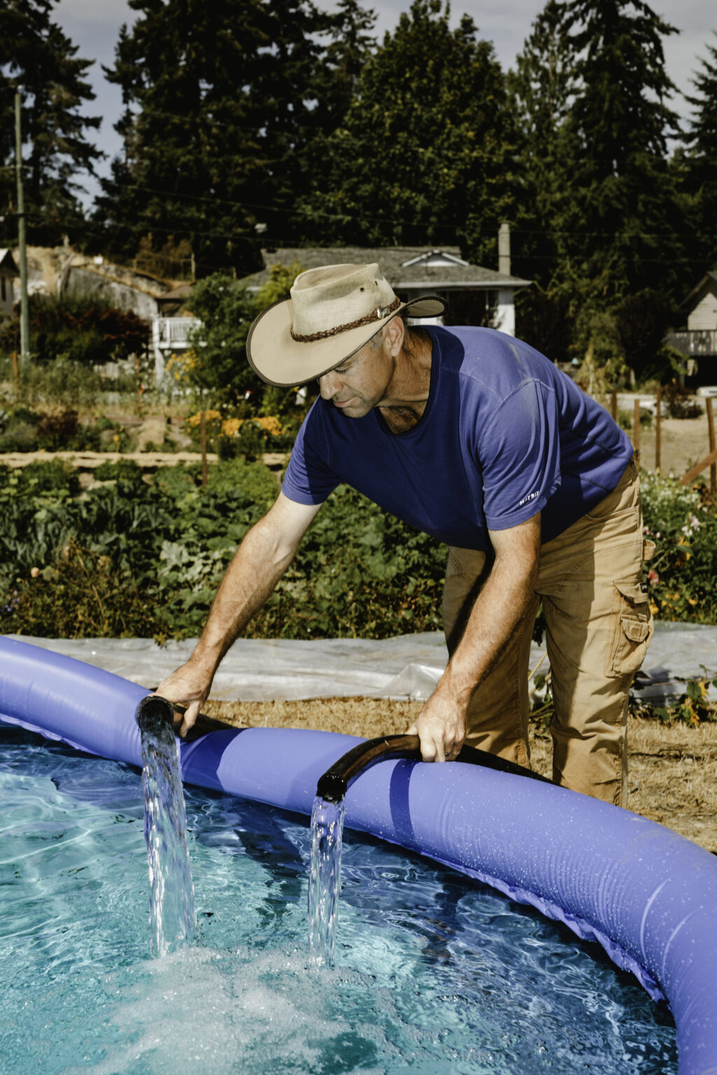 Paul Nash from Ruby’s Run urban farm in Sechelt uses a children’s pool with water in an act of improvised storage.