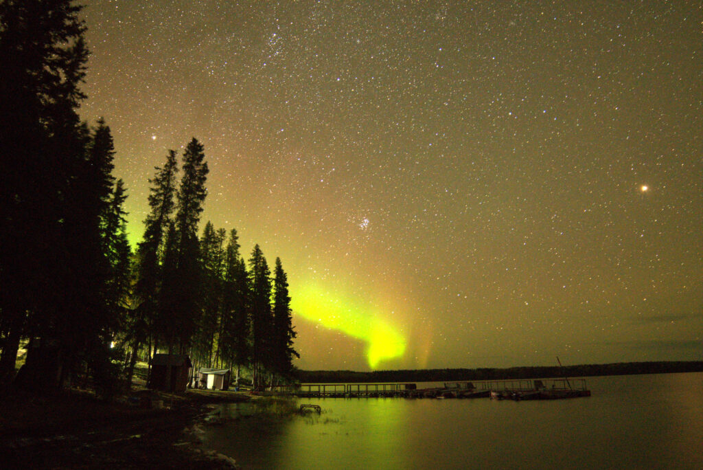 northern lights by a lake