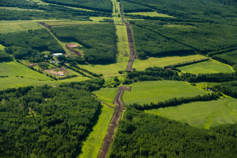 Pipeline cutting across a green landscape in the territory of the Blueberry River First Nation
