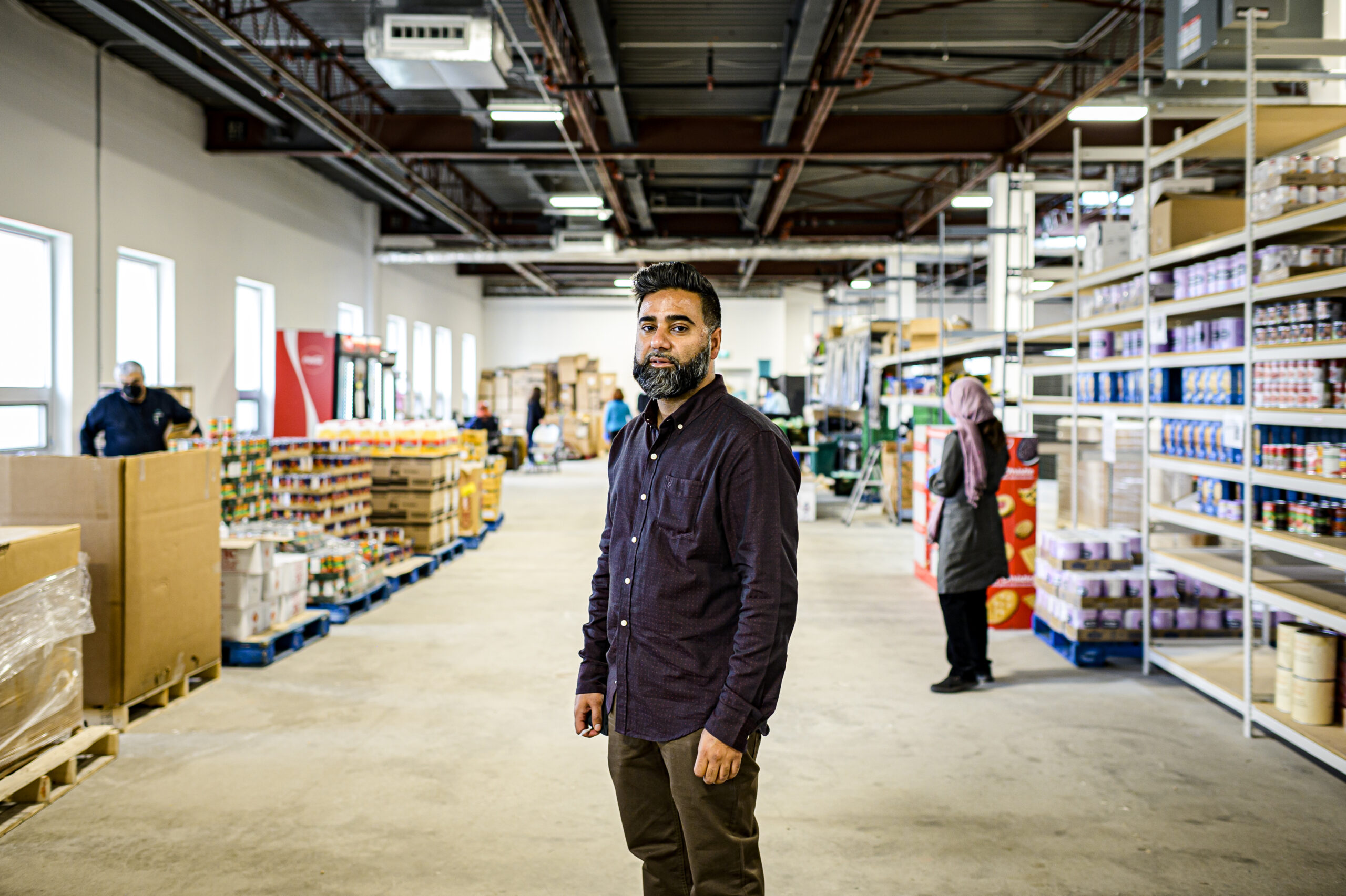Aamir Sukhera stands in a food bank 