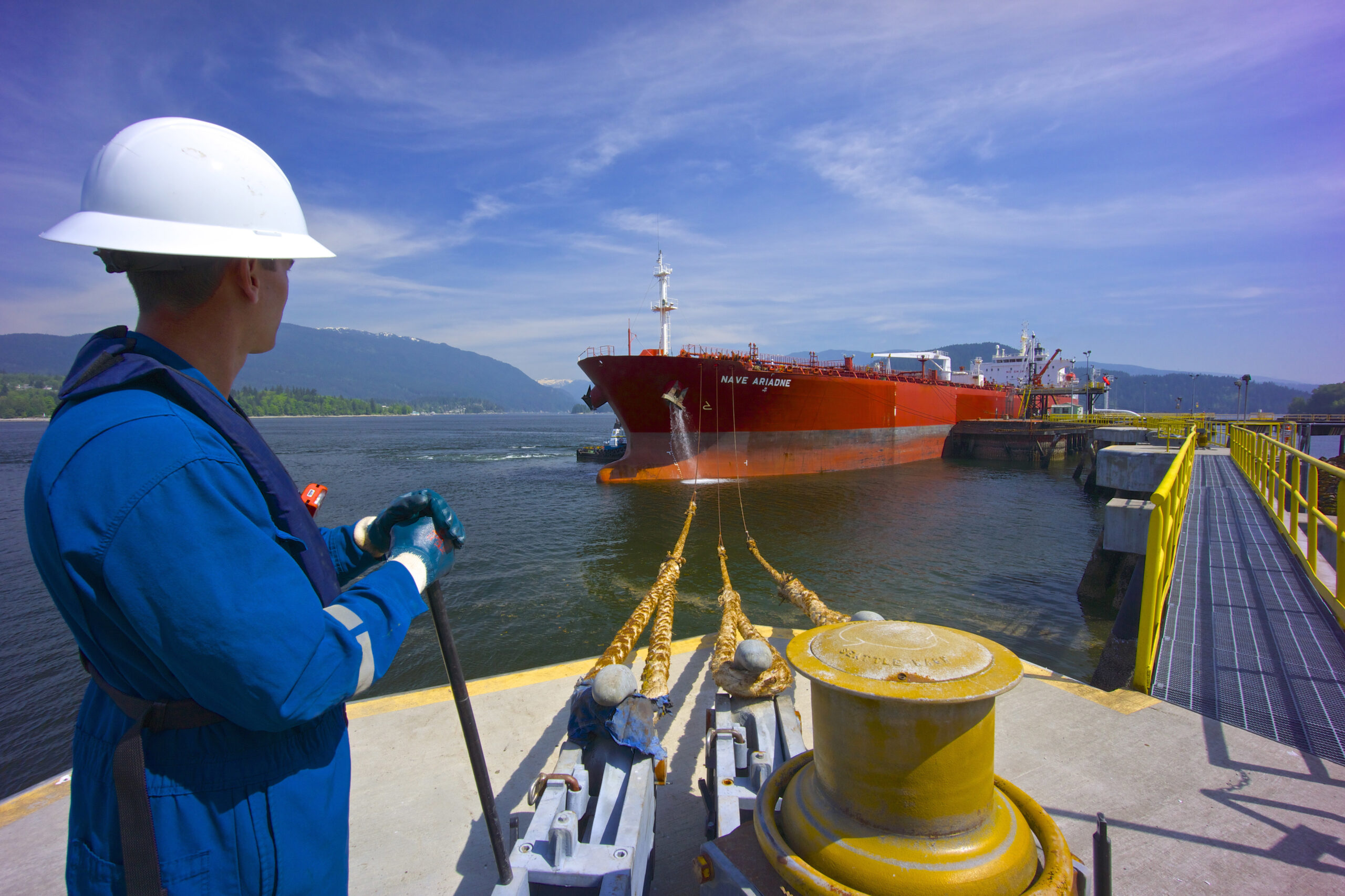 A worker stands on the dock of at the Trans Mountain pipeline terminal in B.C.