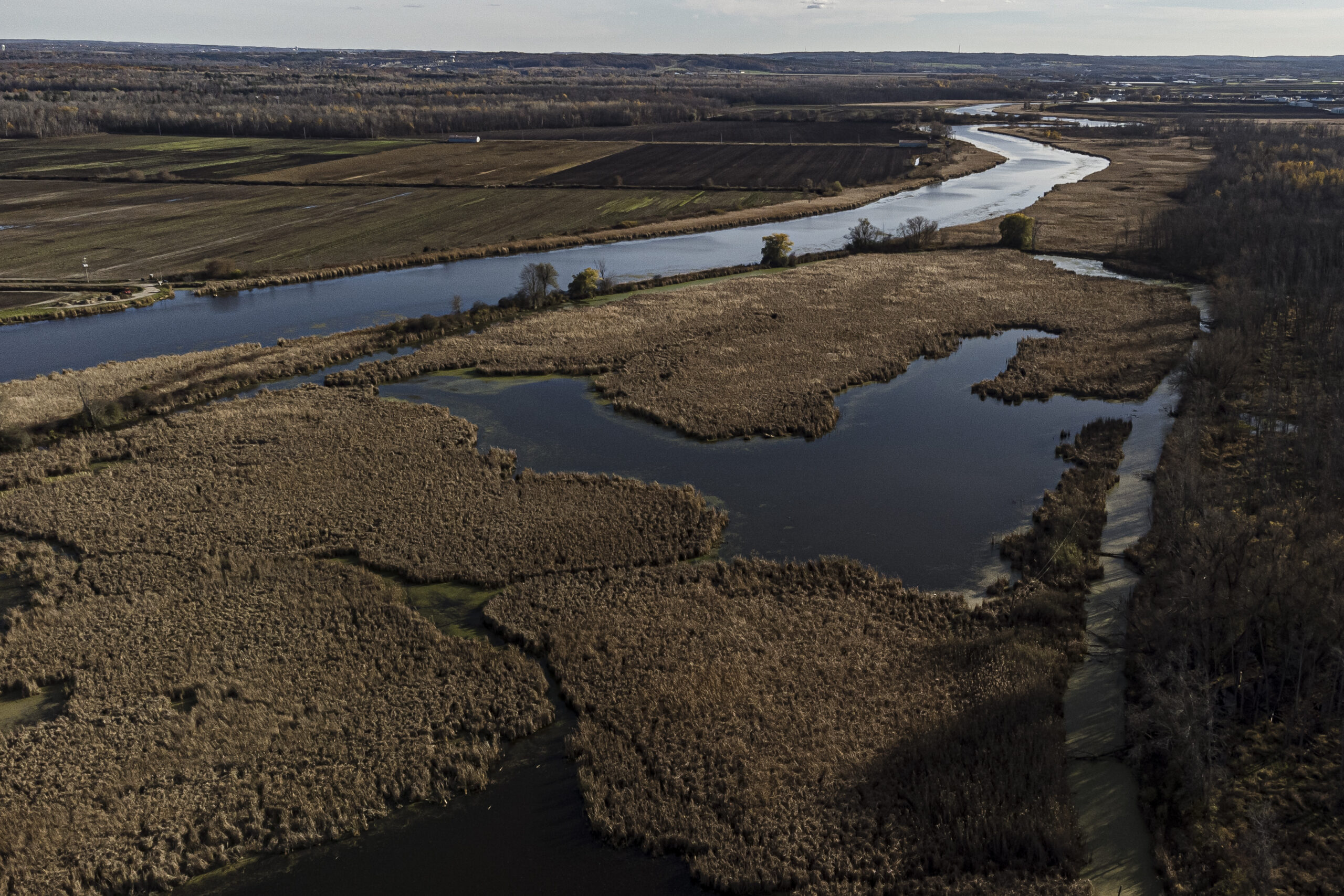 The Holland River in Ontario's Greenbelt winds past farm fields in late autumn. 