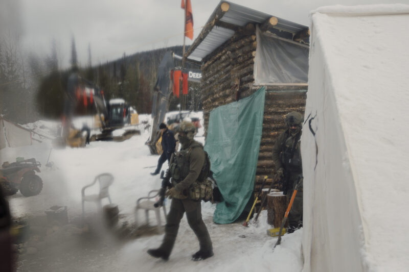 Militarized police move into breach a tiny house at Coyote Camp in Gidimt'en territory near Houston, B.C.