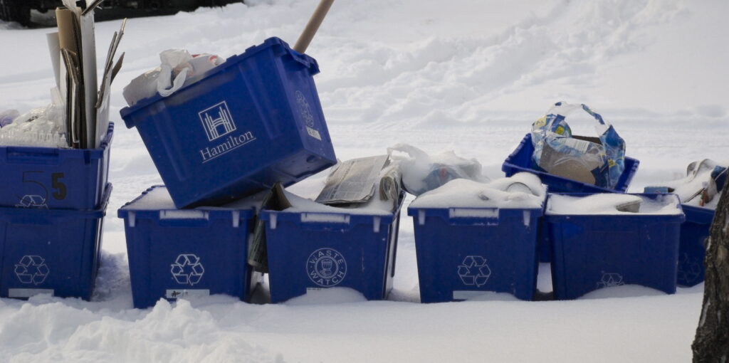 A photo of blue recycling boxes in the snow. The Ford government has overhauled Ontario's recycling program.
