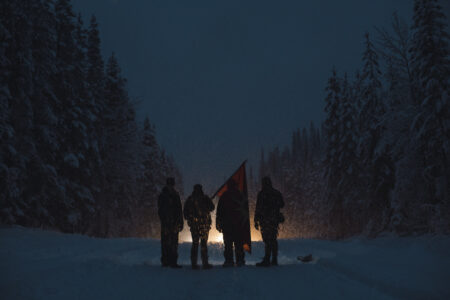 Land Defenders blockade a snowy road to block Coastal GasLink pipeline workers