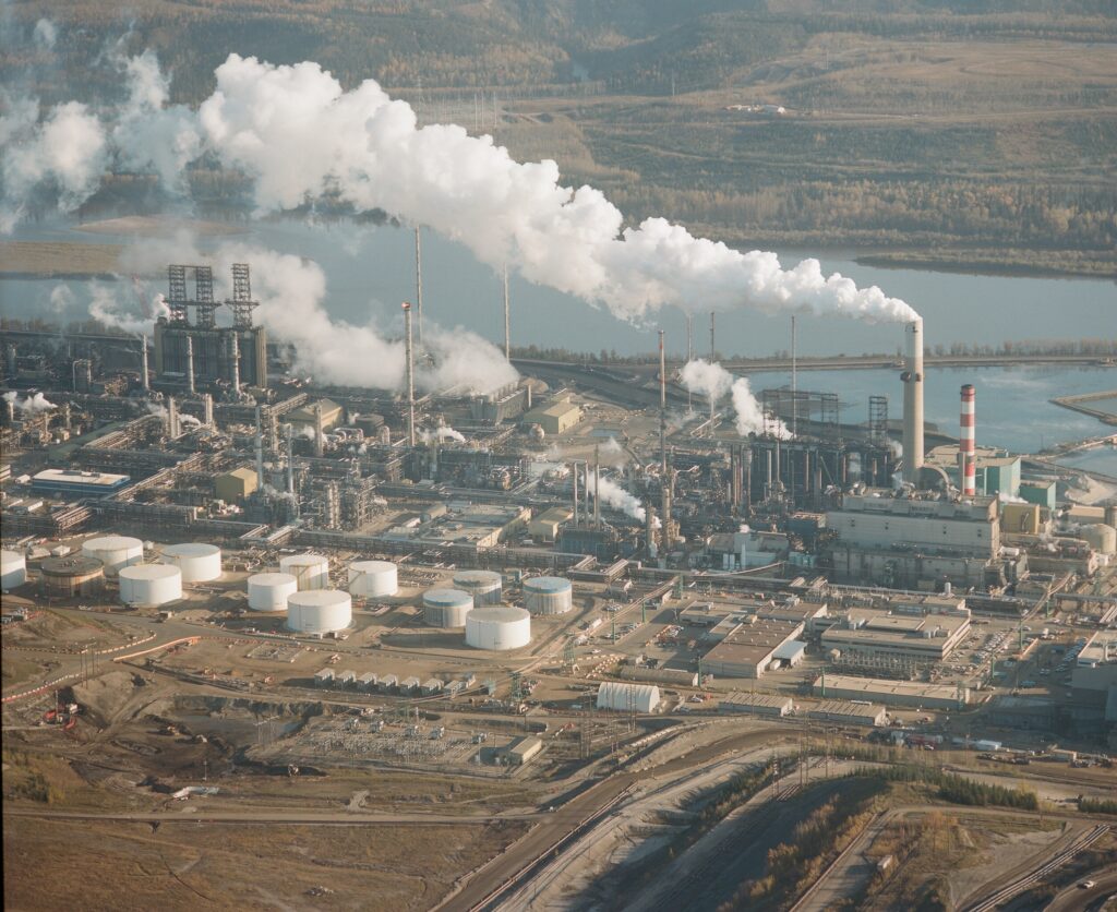 Smoke billowing from stacks at Suncor's oilsands operation; Fort MacMurray, Alberta
