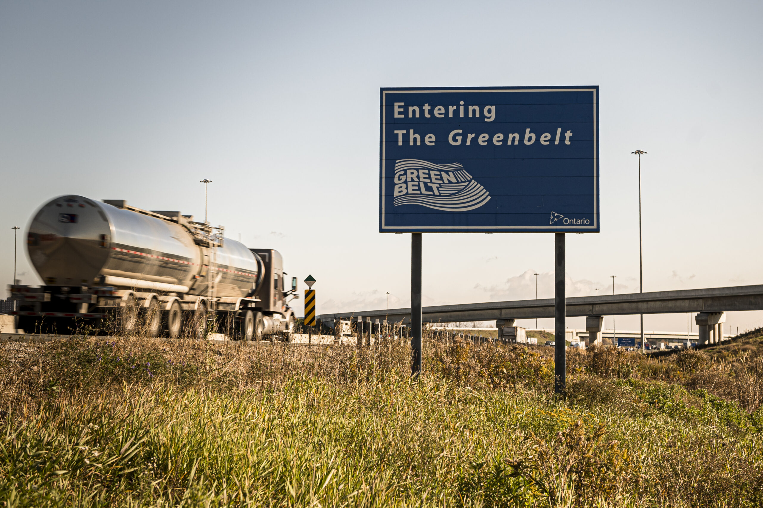 A truck drives past a sign that says "entering the Greenbelt." Ontario Liberal leader Steven Del Duca has vowed to stop Highway 413, which passes through the Greenbelt, if he wins the 2022 Ontario election.