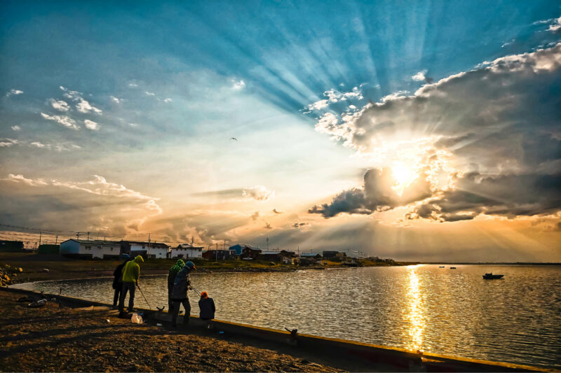 Boys fish at the shore of Arviat, Nunavut