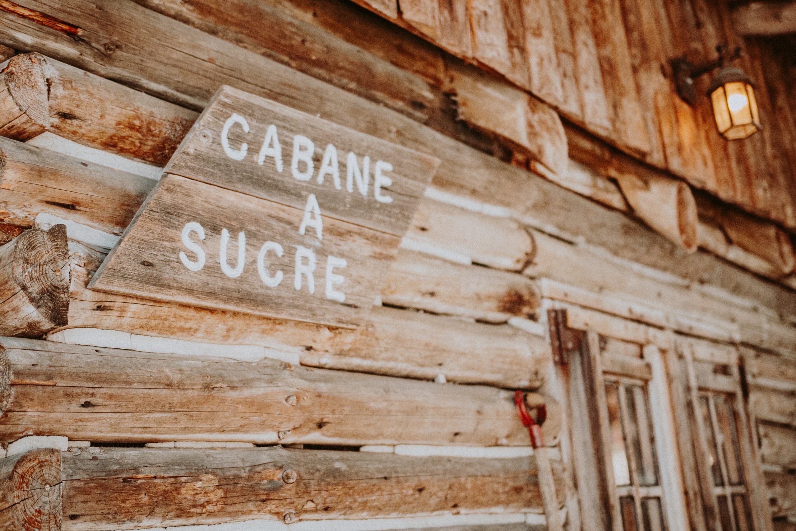 Cabane a sucre painted on a log cabin; sugar shack, Quebec