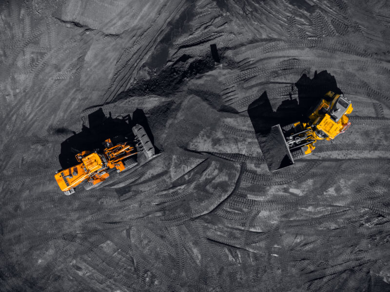 Heavy machinery works in a coal mine.