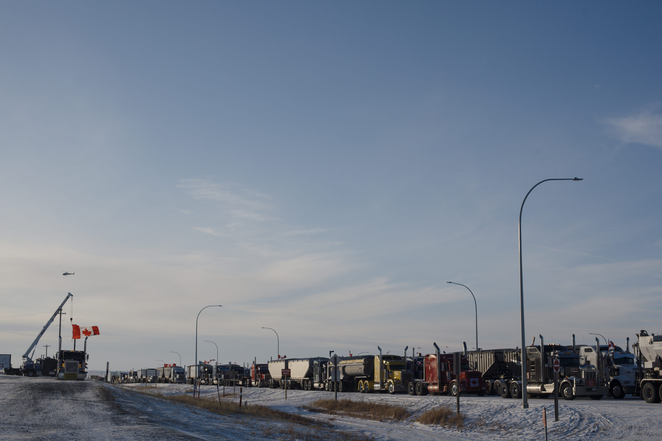 Trucks block the border crossing near Coutts, Alta., while demanding an end to vaccine mandates.