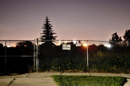 A fence and no trespassing sign at contaminated site in Calgary.