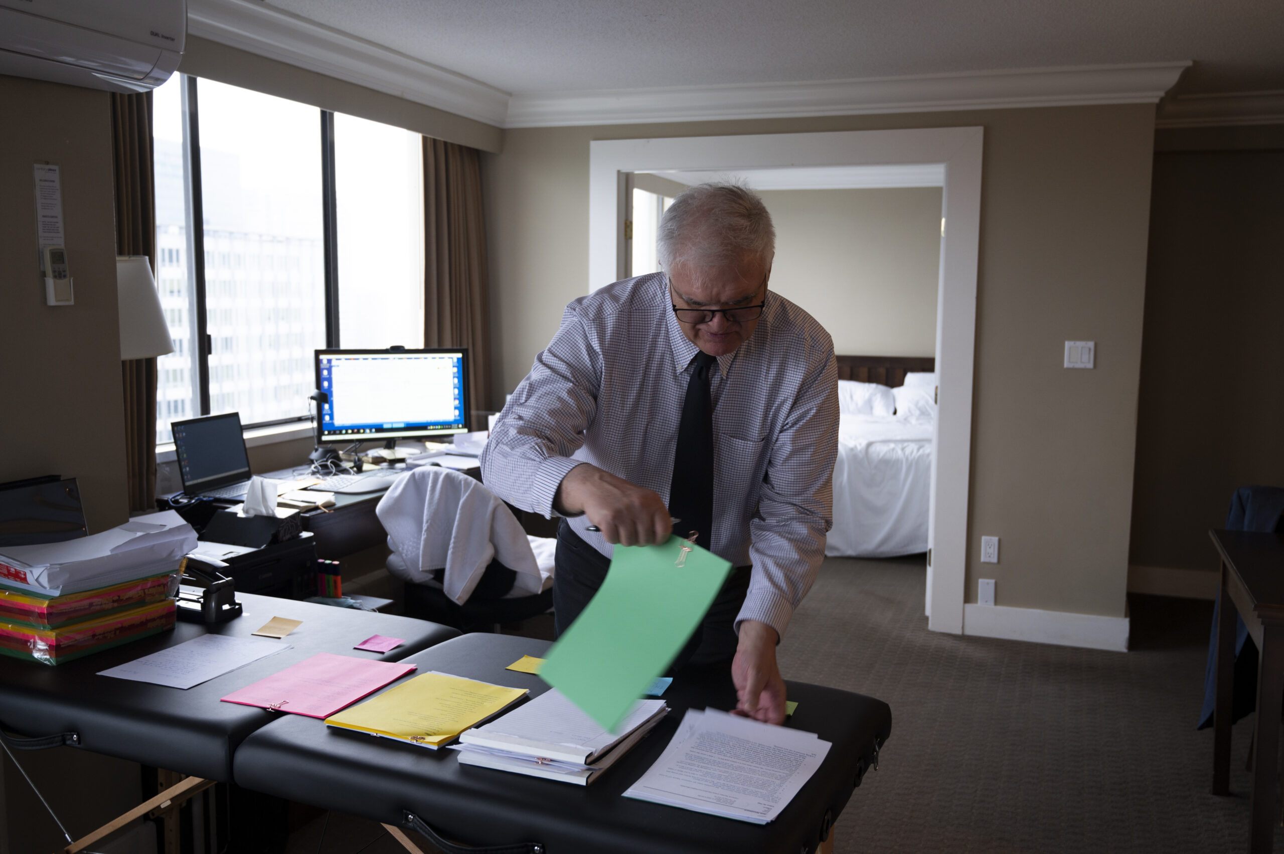Jack Woodward, lawyer for Nuchatlaht Indigenous rights and title case in his hotel room with paperwork