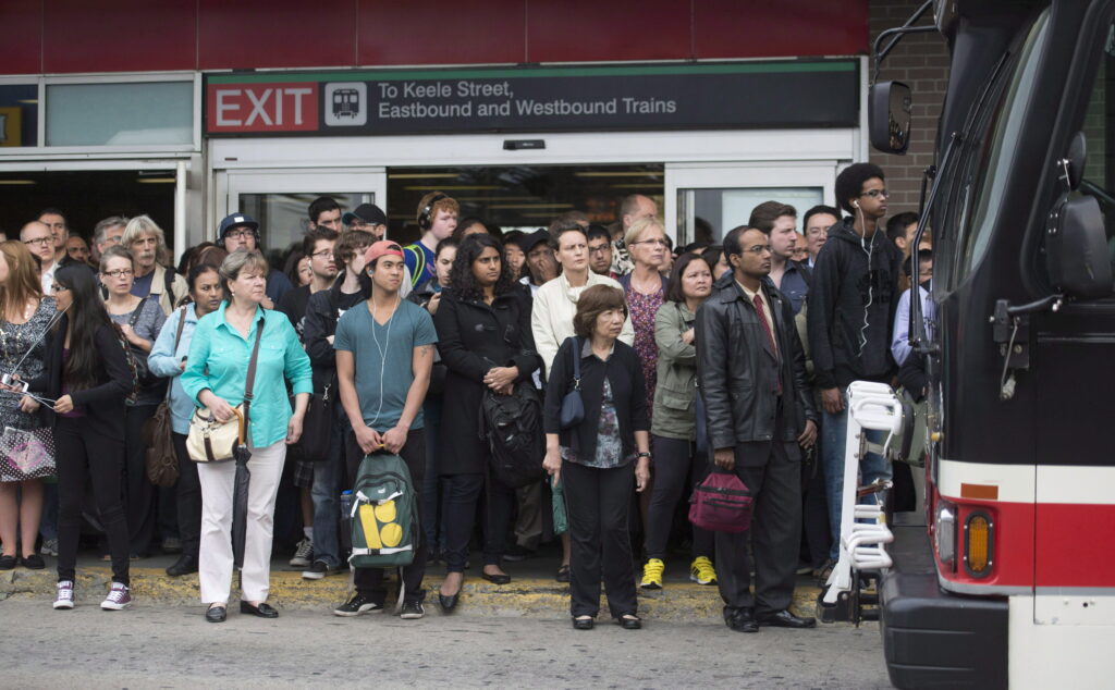 TTC commuters in Toronto wait for a bus.