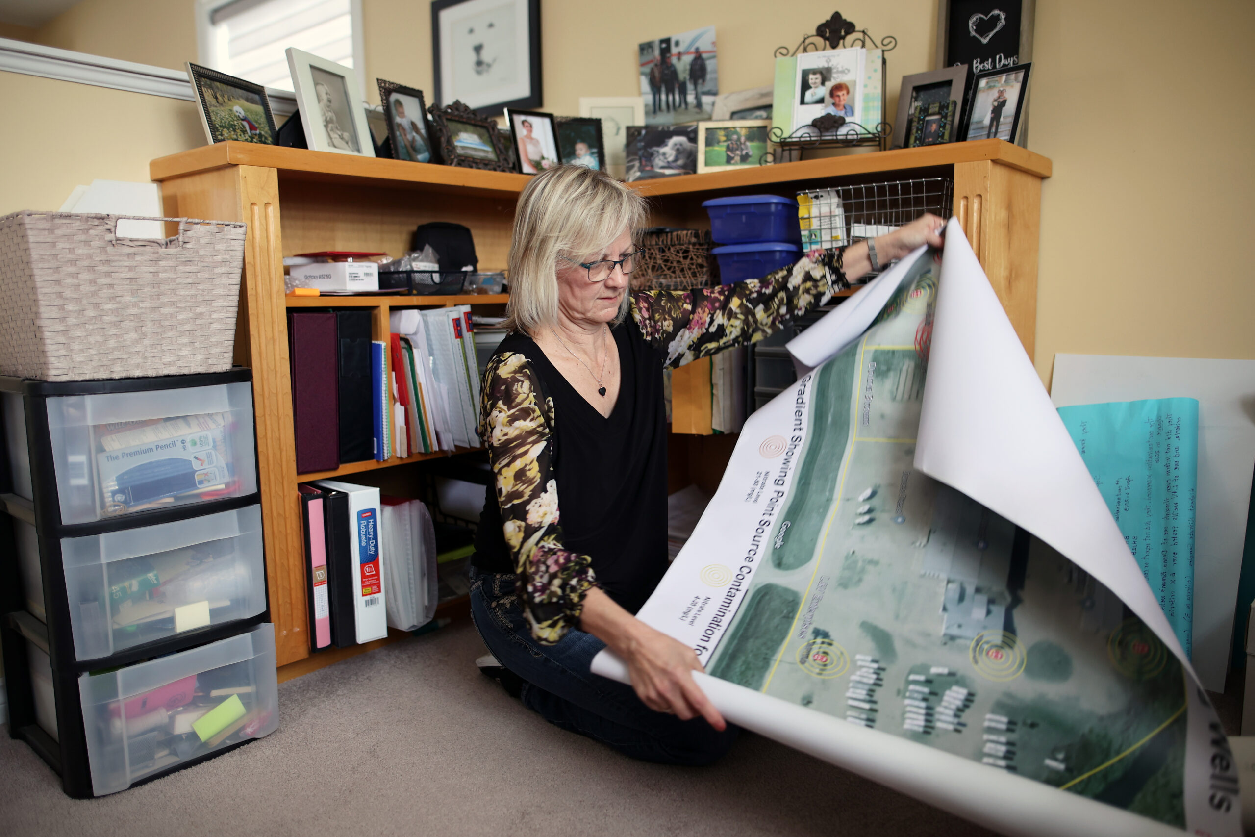 Yorkton, Saskatchewan, business owned Connie Ward looks at maps of contamination from Imperial Oil property next door