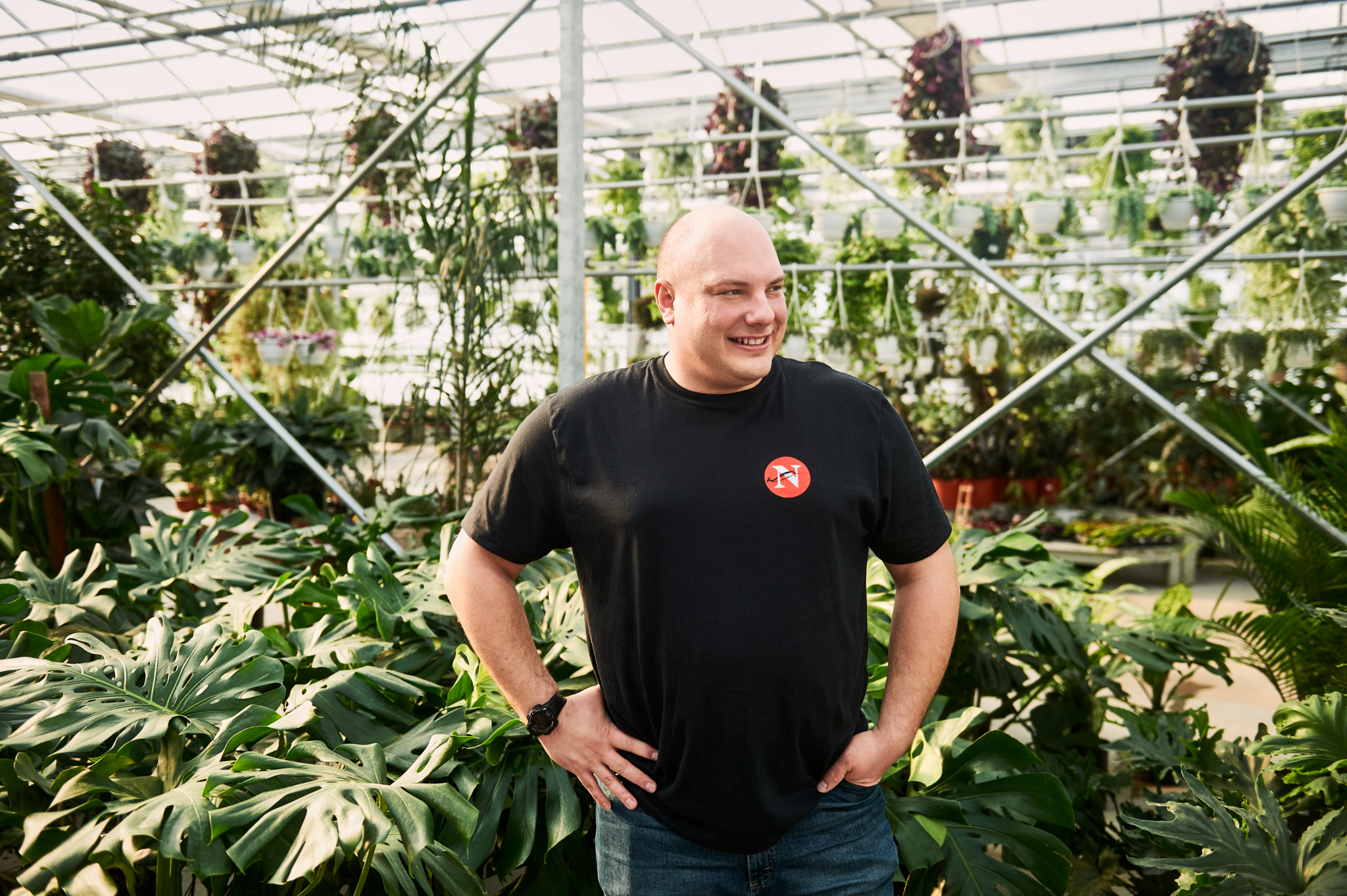 Reporter Carl Meyer is all smiles rocking a Narwhal T-shirt in a greenhouse.