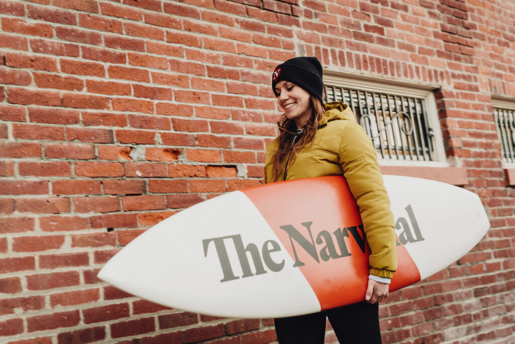 Executive editor Carol Linnitt holds a Narwhal-branded surfboard.