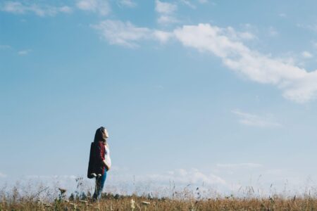 Pregnant woman in field; IPCC report, climate change impacts on pregnant women