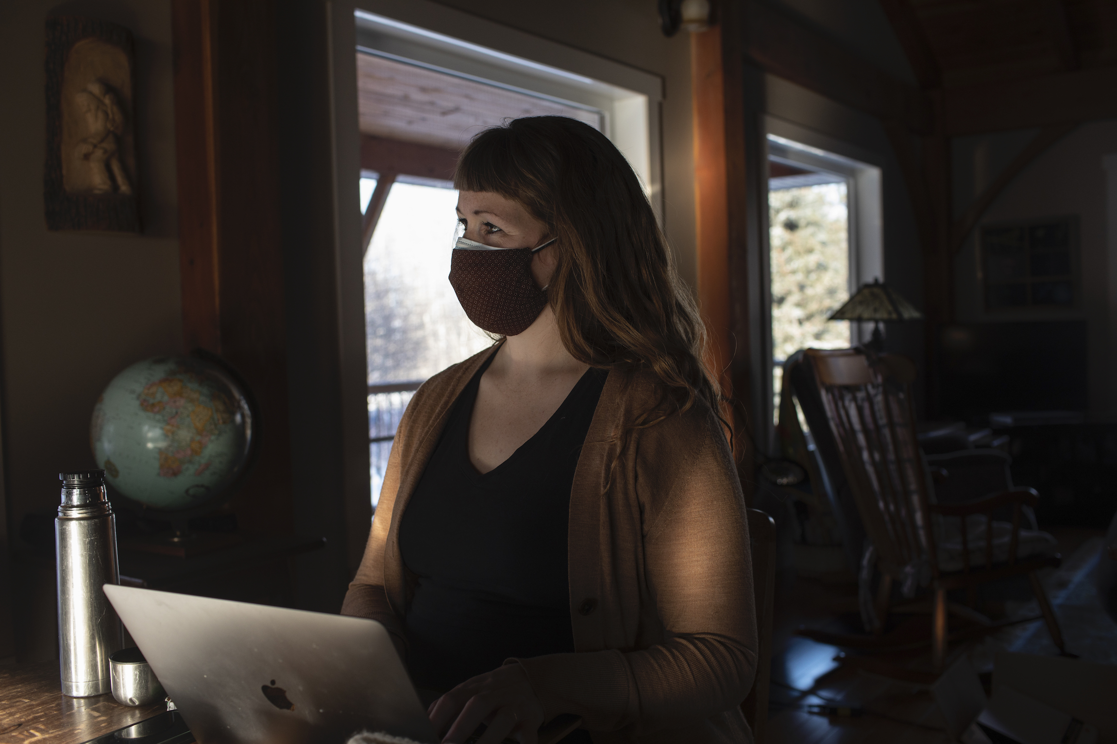 Reporter Sharon Riley is seen wearing a mask as she interviews retired Alberta government scientist Arnold Janz.